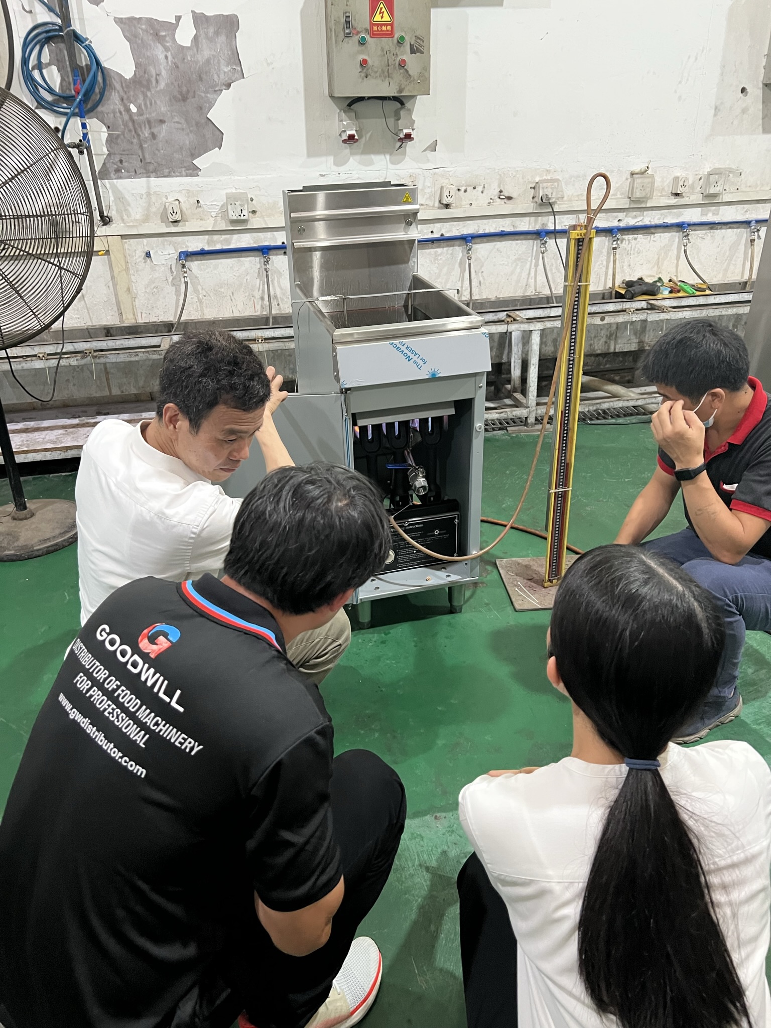 Brian explaining the gas fryer to Goodwill Distributor from Thailand